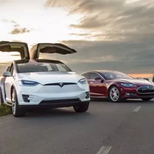 two electric cars tesla on country road