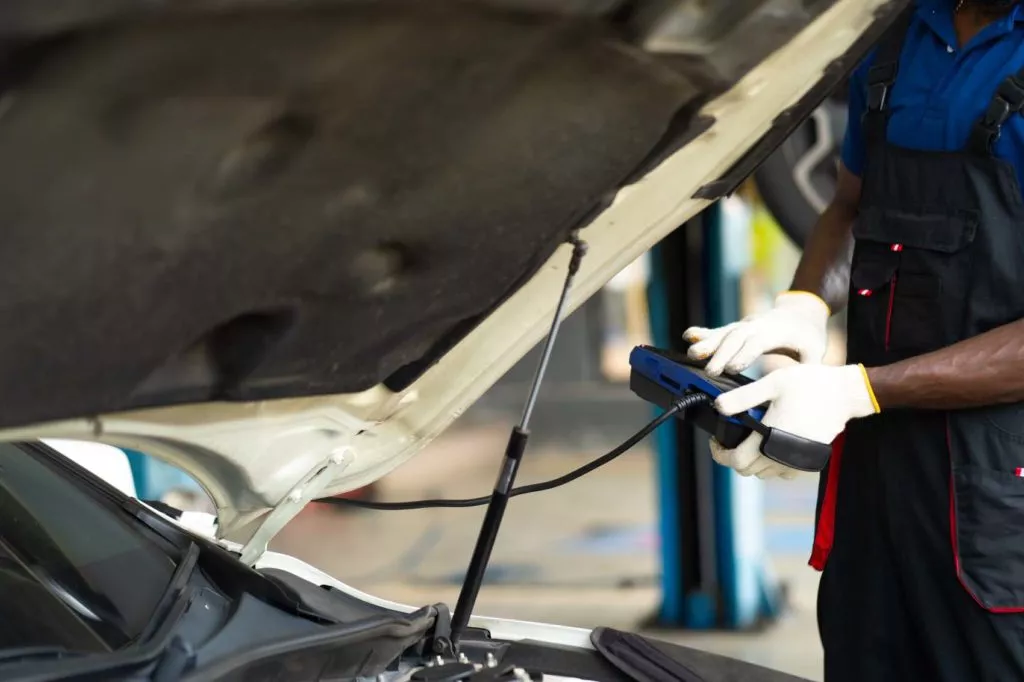 professional car mechanic performing repair service