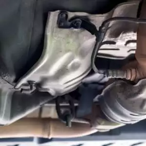 downstream oxygen sensor on catalyst pipe of old gasoline car focused