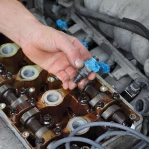 mechanic checking fuel injector