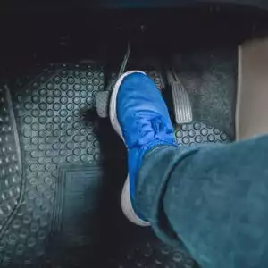 driver stepping on a brake pedal