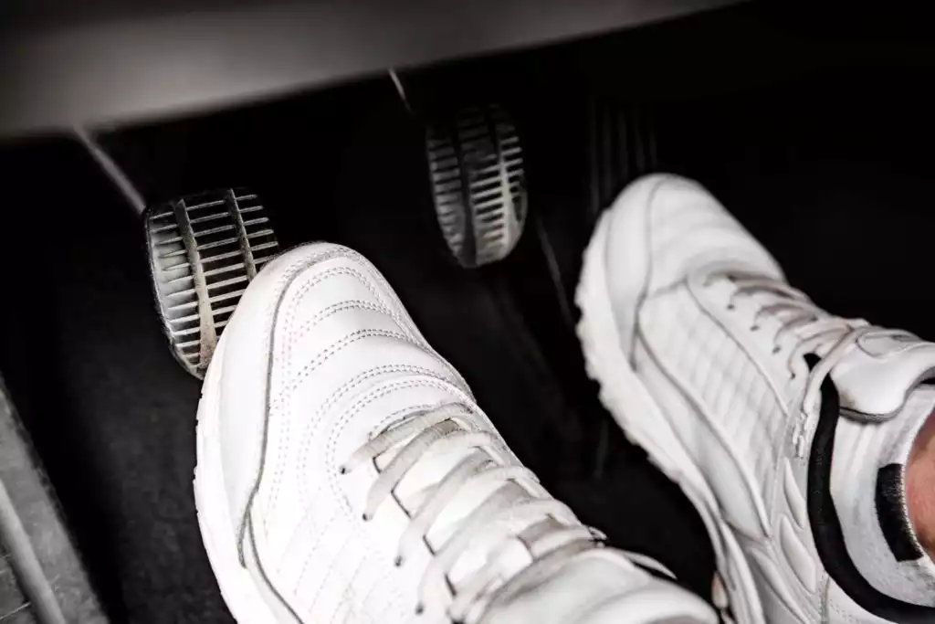 foot pressing the clutch pedal