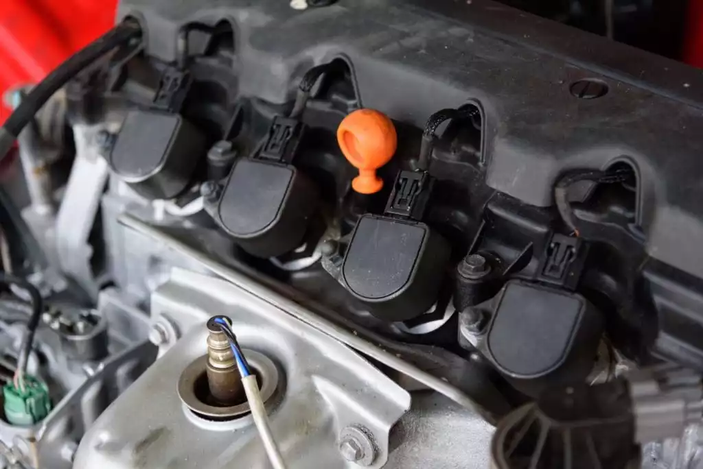 modern car engine with four ignition coils aligned