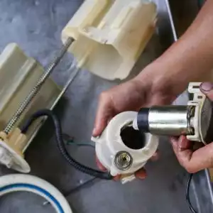mechanic hand installing an electric fuel pump
