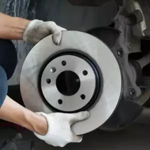 man holding brake disc that can be placed in front or rear brake