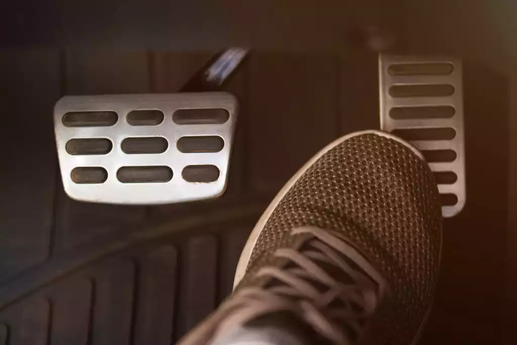 driver pressing the gas pedal to accelerate