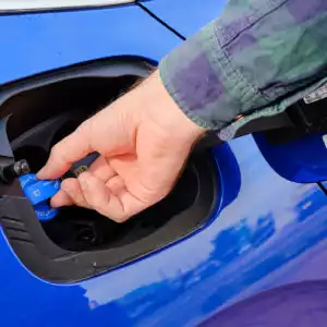 man checking car def cap