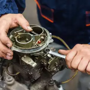 carburetor being repaired by mechanic