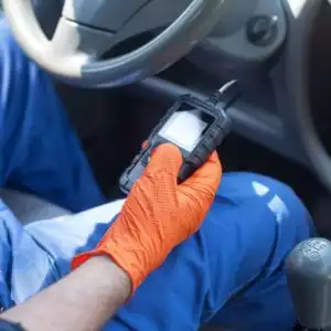 mechanic holding a diagnostic scan tool