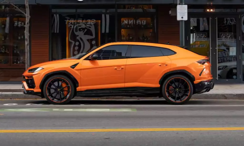 parked orange lamborghini urus
