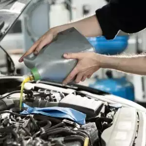 pouring of new engine oil for car