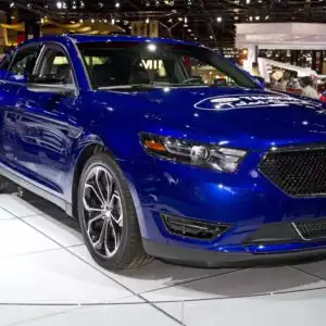 blue 2013 ford taurus on display
