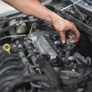 automotive mechanic testing and checking ignition coils