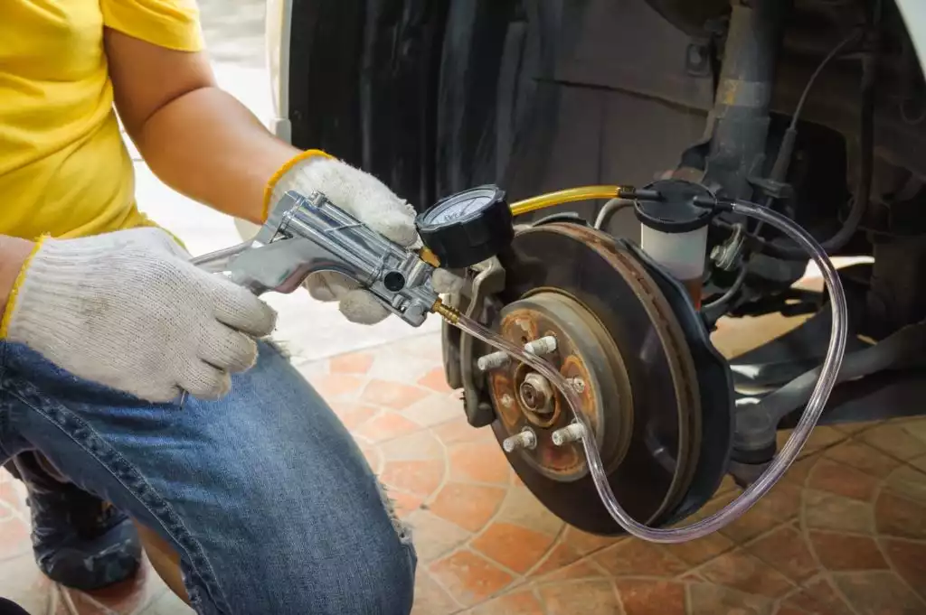 mechanic bleeding brakes