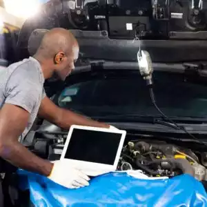 mechanic diagnosing car engine