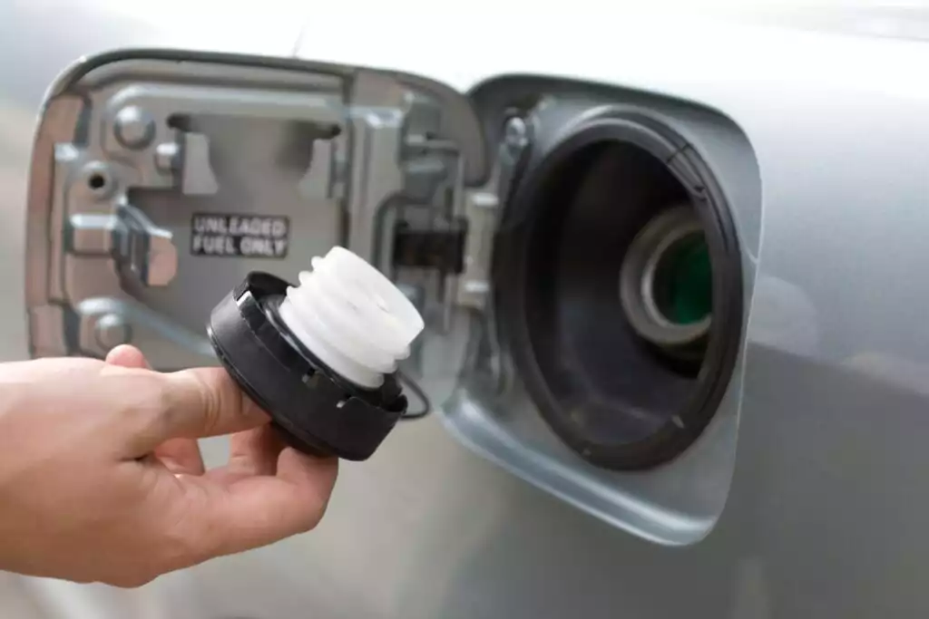 hand holding a car gas cap