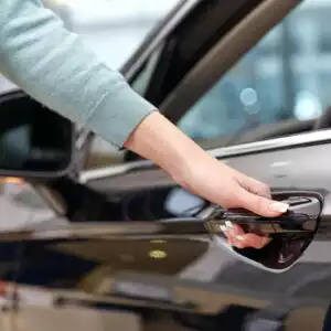 woman opening a car door handle