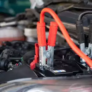 jumper cables connected to a car battery