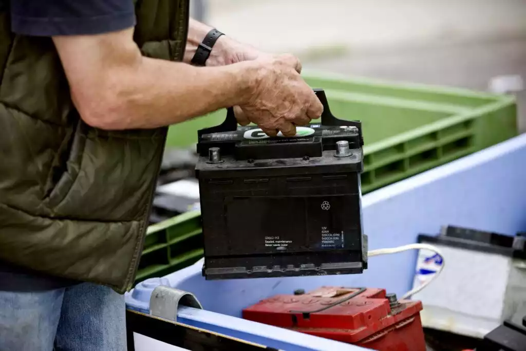 man disposing a car battery