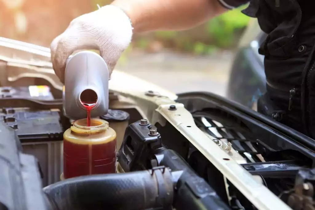pouring power steering fluid in the reservoir