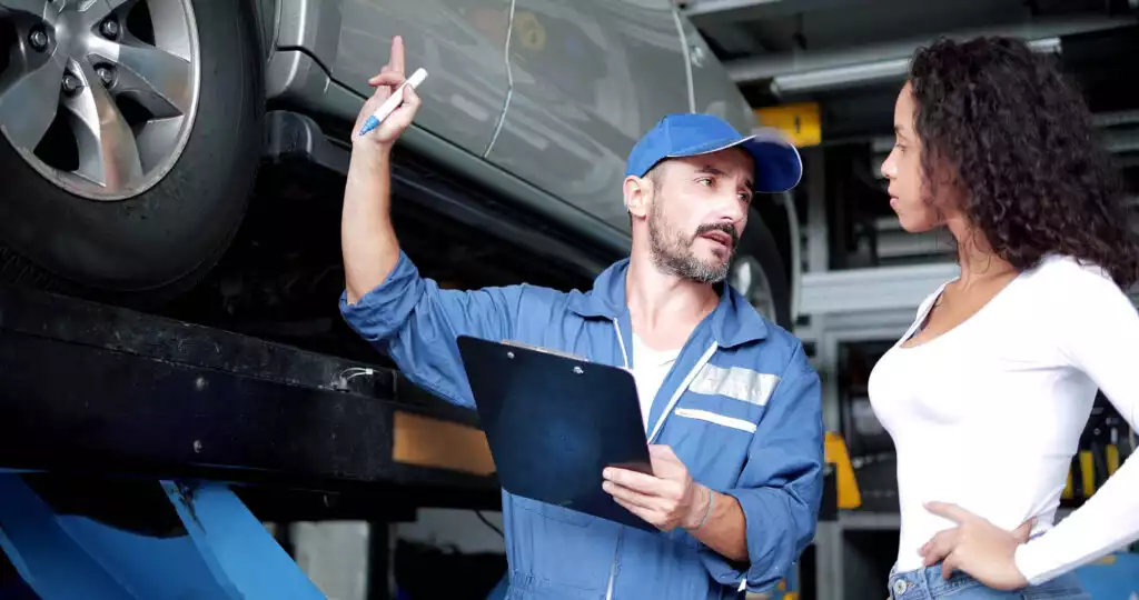 mechanic explains car issue to customer