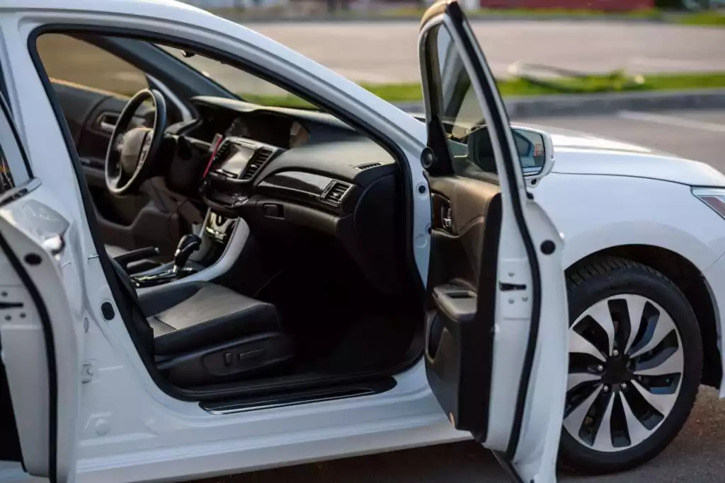 white car with open doors and windows