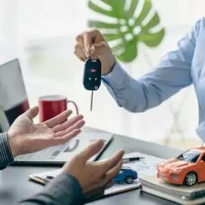 car agent handing keys to the customer