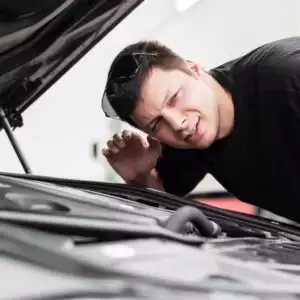 man listening to the car's engine sound