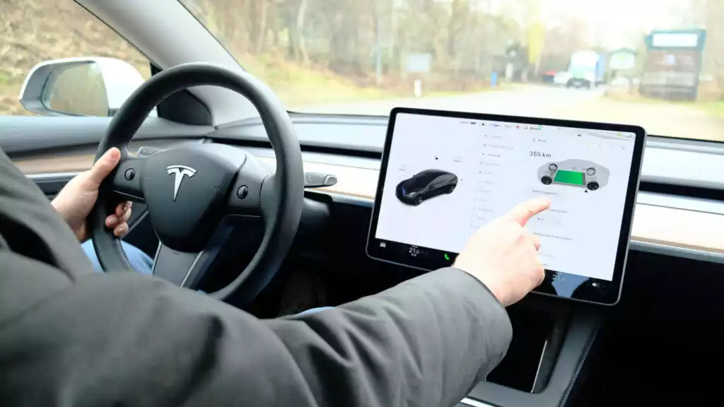 Male,Sits,Behind,Wheel,In,Car,And,Uses,Electronic,Dashboard