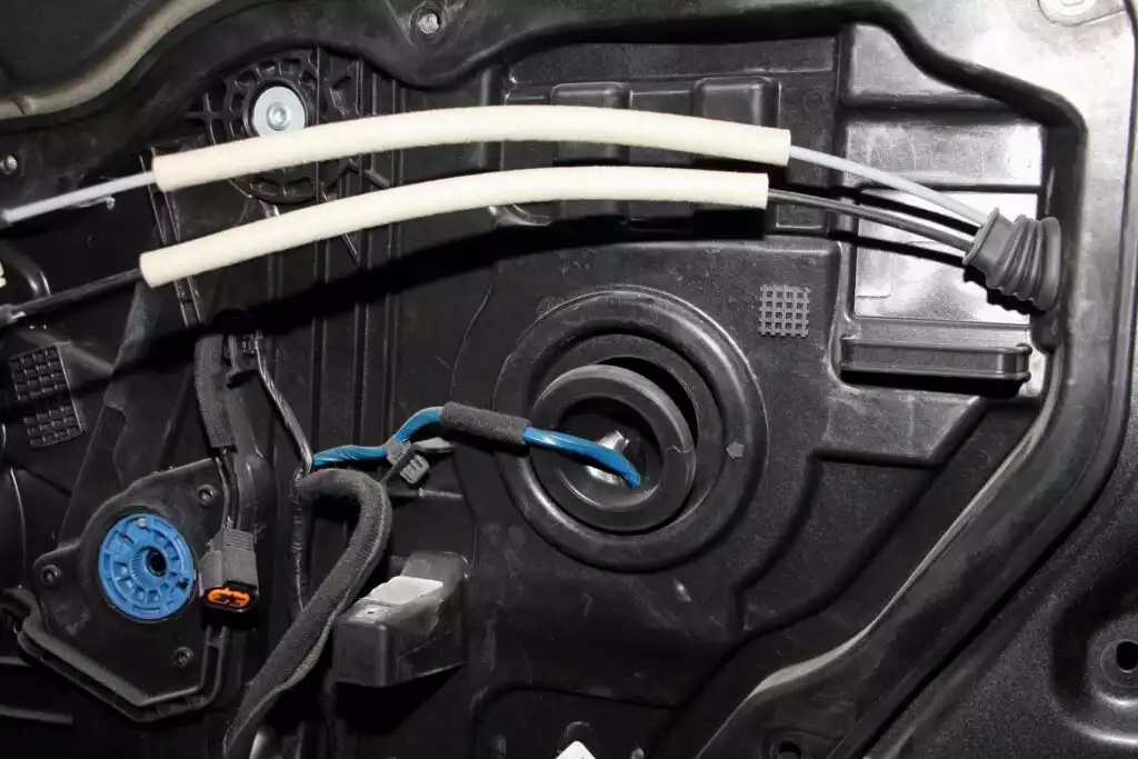 inside a car door showing window regulator and motor