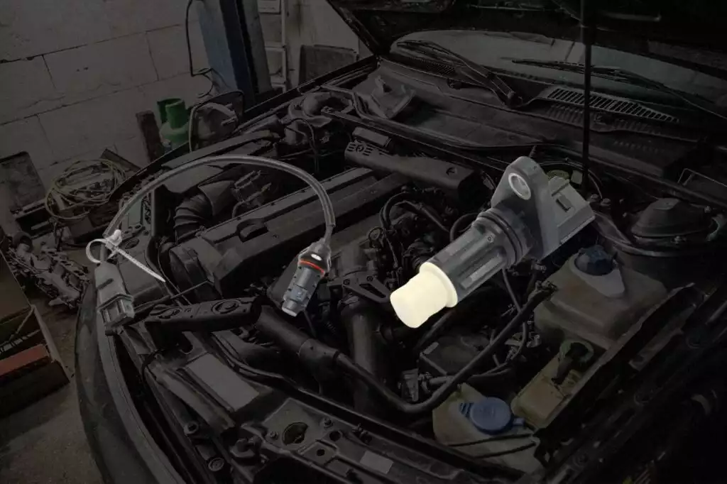 crankshaft sensor located under car hood