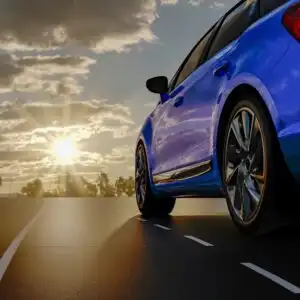 blue car driving on the road