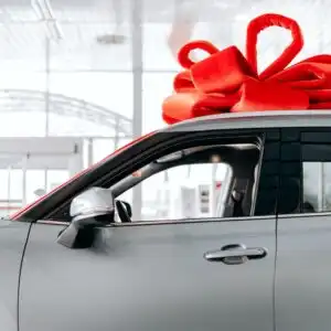 car with red ribbon on top
