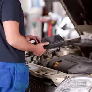 mechanic checking car engine