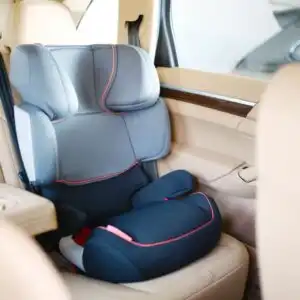 blue car seat installed in a luxury car