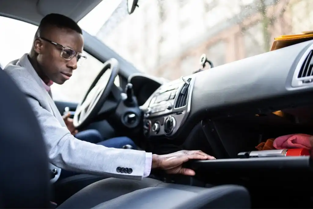 man opening car glove box