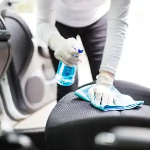 woman cleaning the the car seat