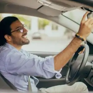 defensive driver checking rear view mirror