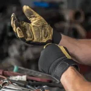 man using mechanic gloves
