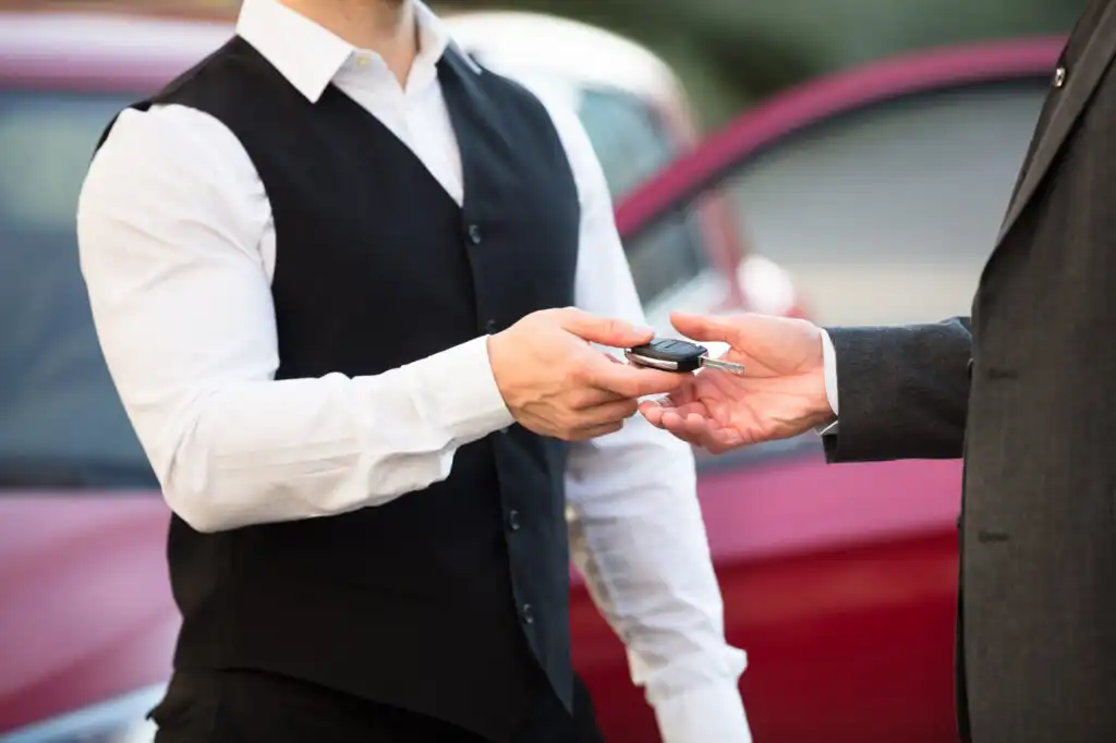 valet attendant returning car key