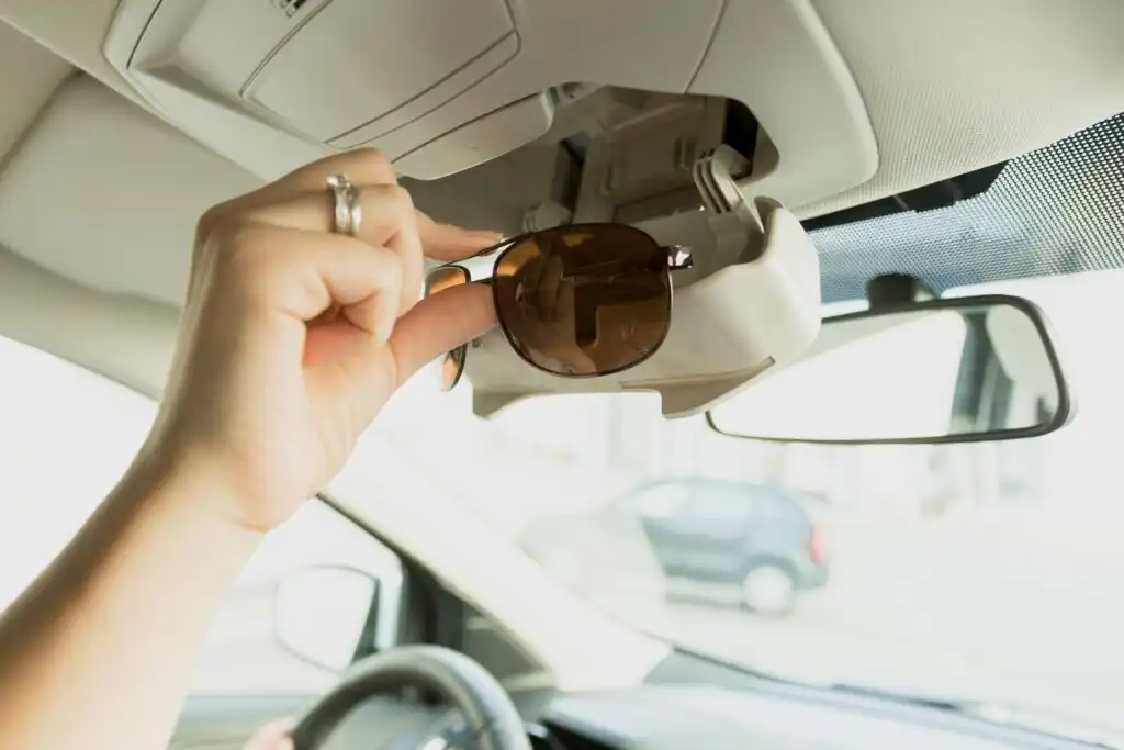 driver putting out sunglasses