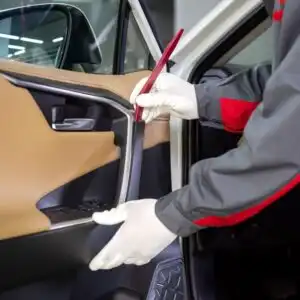 mechanic using a trim removal tool