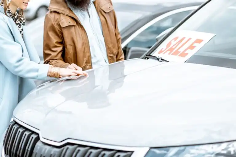 couple checking a used car for sale