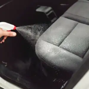 spraying a car interior cleaner