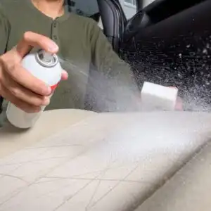 spraying car seat stain remover