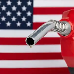 gas pump nozzle with us flag in the background
