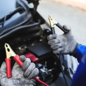 person holding jumper cables
