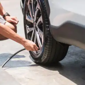 putting air to a car tire