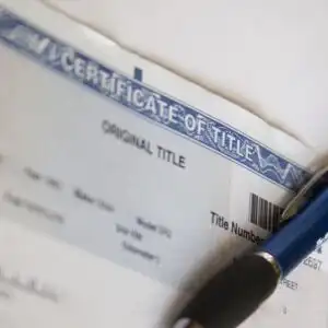 car title and pen