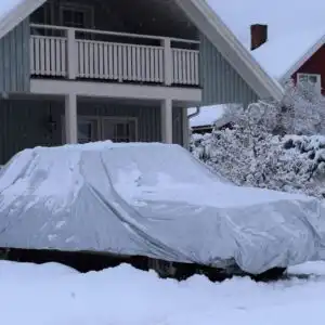car with a cover during a snowstorm